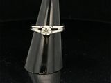 a close up of a diamond ring on a black surface