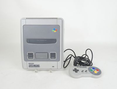 a nintendo classic game console with a controller next to it