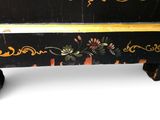a black and yellow chest with a floral design on it