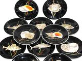 a lot of black plates with shells and seashells on them