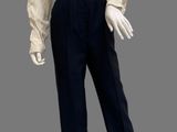 mannequin wearing a white shirt and black pants with a frillying collar
