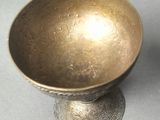 a metal bowl sitting on top of a table