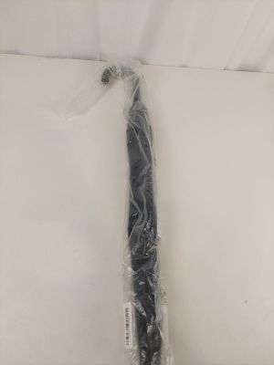 a close up of a black umbrella wrapped in plastic on a white surface