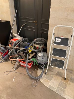 a pile of assorted items on the floor next to a door