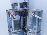 several cans of paint are stacked on top of each other