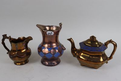 three pieces of antique brass and blue glass on a white surface