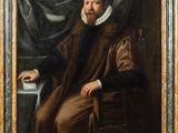 portrait of a man with a book in a chair