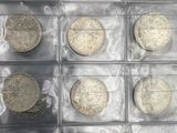 a lot of coins that are in a plastic box