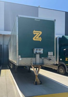 two trucks that are parked in front of a building
