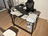 a desk with a chair and a computer on it