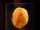 a small glass object with a piece of food inside of it