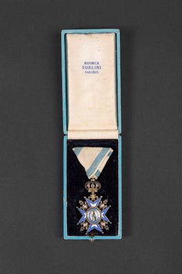 an image of a medal in a blue box on a black surface