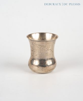a silver cup that is sitting on a table