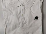 white polo shirt with a black cat on the collar