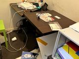 a desk with a computer and a printer on it in a room