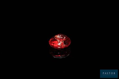 a red candle that is lit up in the dark