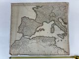 an old map of europe with a ruler on a table