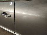 a silver car that has a broken door handle on it