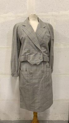 grey and white checkered jacket and skirt suit on a mannequin