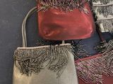 three purses with fringes on them sitting on a table