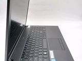 a laptop with a black keyboard sitting on a white surface