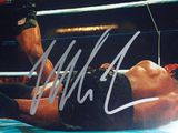 an image of a man laying on the ground in a wrestling ring