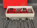a red box with silverware in it on a table