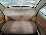a seat in the back of a car with a window open
