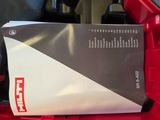 a red box with a black and white label sitting on top of it