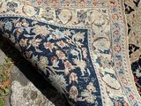 a rug on the ground next to some rocks