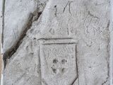 relief représentant des armoiries et un bouclier sur un bloc de pierre