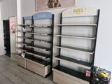 many shelves that are lined up in a room