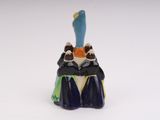 a small figurine of a cat sitting on top of a table