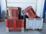 two red crates sitting next to each other on the ground