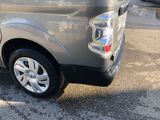 the back end of a silver truck parked in a parking lot