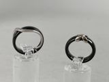 pair of black and white rings on clear acrylic stand