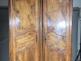 a large wooden armoire in the middle of a room