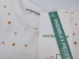 a white shirt with stars on it and a tag on it