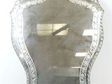 a large silver mirror on the wall in the room