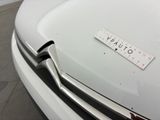 a close up of a white car with a sticker on it