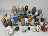 many different types of eggs and vases on the table