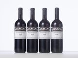 three bottles of red wine sitting on top of a white table