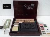a wooden box with a set of stamps and a brush