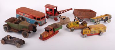 a lot of toy cars and trucks that are on a white surface