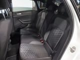 the back seats of a white car with a black seat belt