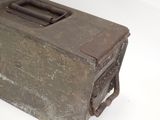 an old metal box with a handle on a white surface