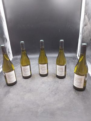 six bouteilles de vin sont alignées sur un comptoir