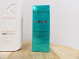 a bottle of kerastase on a table next to a bottle of conditioner