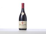 a bottle of red wine sitting on top of a table