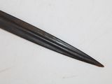 a knife that is laying on a white surface
